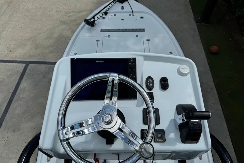 Slide: The Image of 2020 Yellowfin 24 Bay CE boat console with steering wheel and controls. - 28