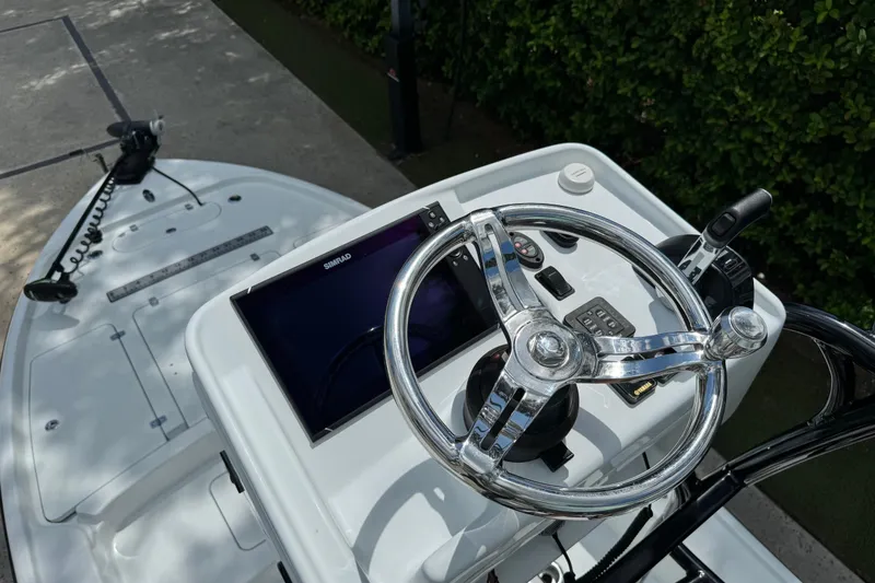 Slide: The Image of 2020 Yellowfin 24 Bay CE boat helm with steering wheel and navigation display. - 29