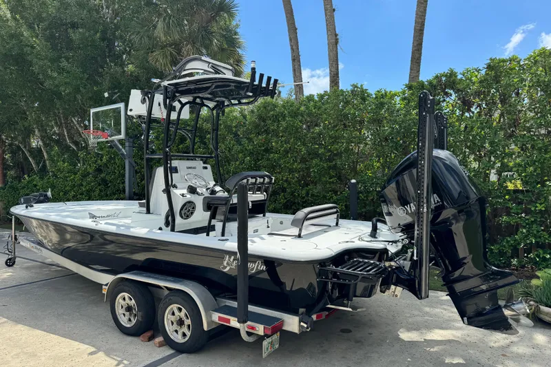 Slide: The Image of 2020 Yellowfin 24 Bay CE boat on trailer, parked outdoors with lush greenery. - 3