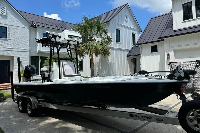 Slide: The Image of 2020 Yellowfin 24 Bay CE boat on trailer in front of modern white house. - 6