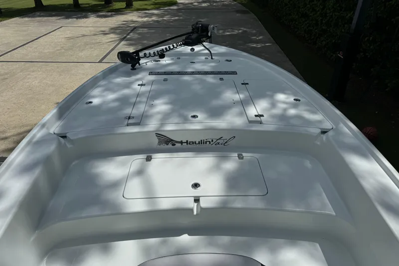 Slide: The Image of 2020 Yellowfin 24 Bay CE boat on driveway, featuring sleek white deck design. - 7
