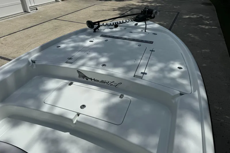 Slide: The Image of 2020 Yellowfin 24 Bay CE boat deck with storage compartments and trolling motor. - 8