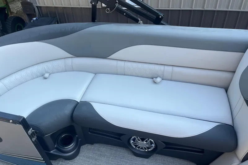 Slide: The Image of 2023 Avalon LSZ 2585 QL boat interior with gray and white cushioned seating. - 6