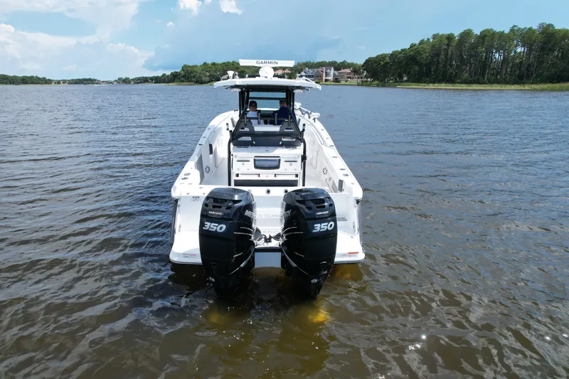 Slide: The Image of 2021 Blackfin 332 CC boat with twin 350 engines on a calm lake. - 11