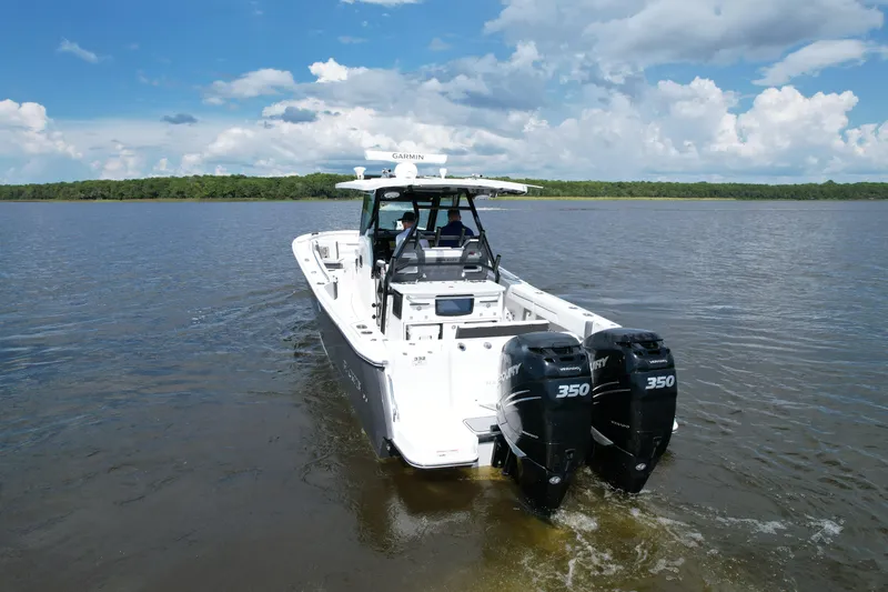 Slide: The Image of 2021 Blackfin 332 CC boat with twin Mercury 350 engines on a calm lake. - 14
