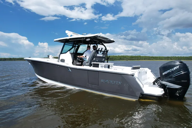 Slide: The Image of 2021 Blackfin 332 CC boat on water, featuring Mercury engines and Garmin equipment. - 20