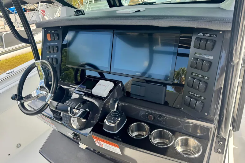 Slide: The Image of 2021 Blackfin 332 CC boat dashboard with dual screens and control panel. - 21