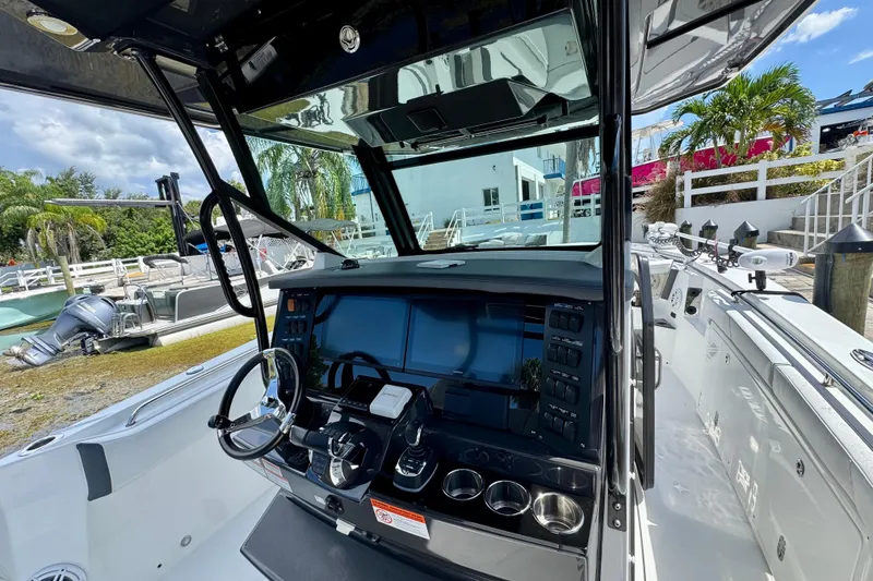Slide: The Image of 2021 Blackfin 332 CC boat cockpit with modern controls and steering wheel. - 22