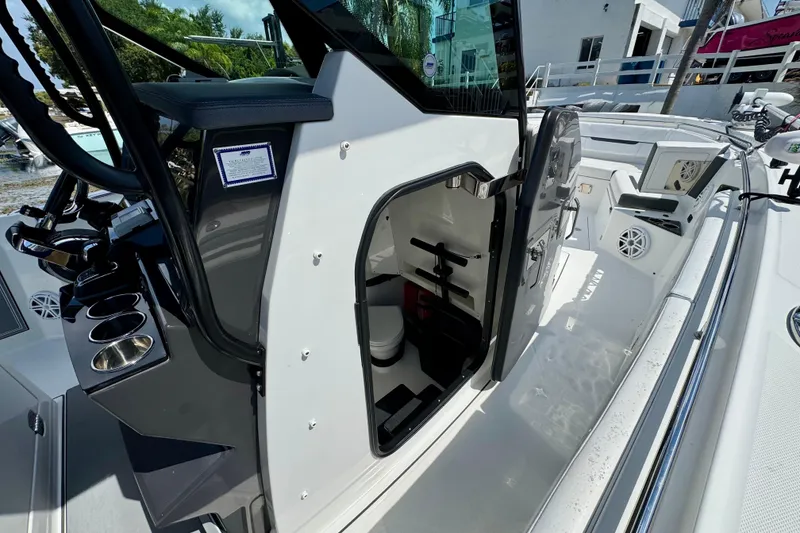 Slide: The Image of 2021 Blackfin 332 CC boat interior with open cabin door, showcasing sleek design and amenities. - 24