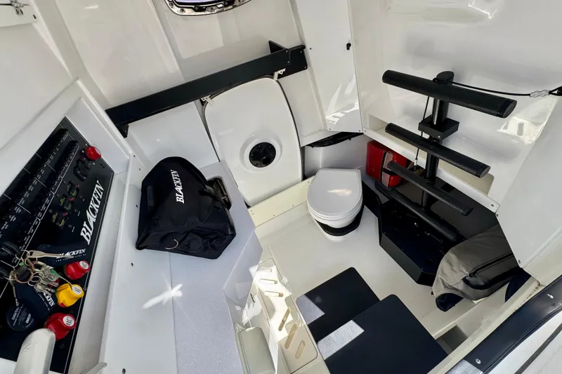 Slide: The Image of Interior of 2021 Blackfin 332 CC boat featuring a compact cabin with seating and storage. - 25