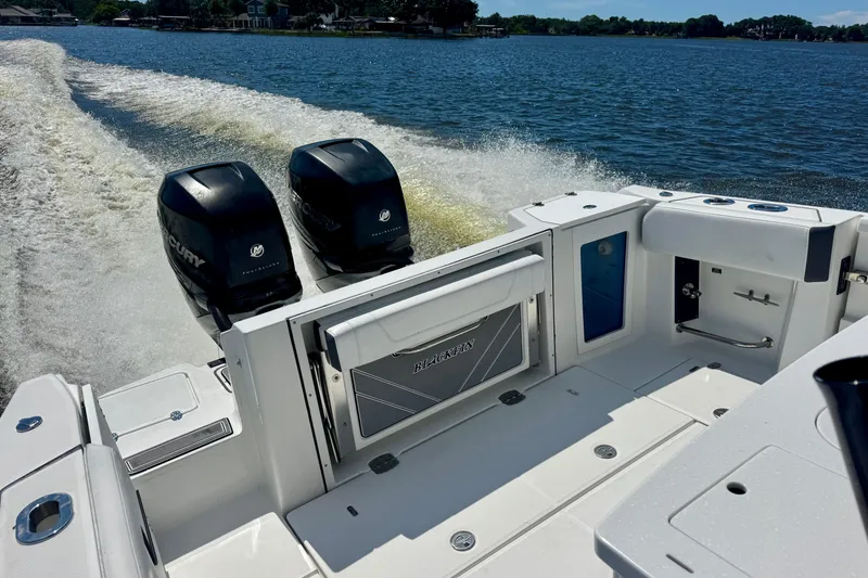 Slide: The Image of 2021 Blackfin 332 CC boat with dual Mercury engines cruising on a lake. - 37