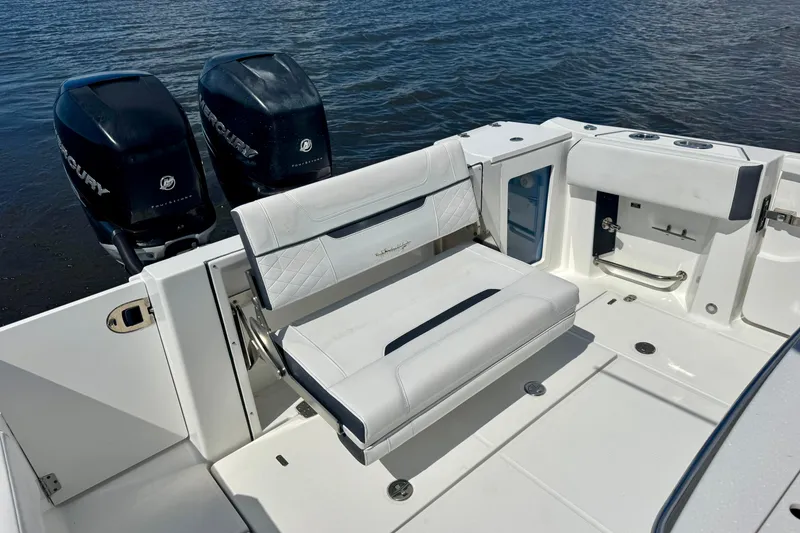 Slide: The Image of 2021 Blackfin 332 CC boat with dual Mercury outboard engines and white seating. - 38