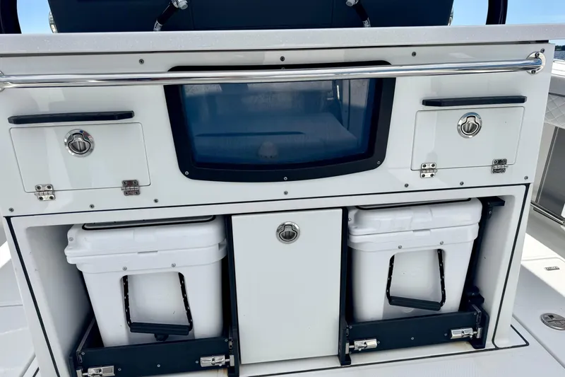 Slide: The Image of 2021 Blackfin 332 CC boat console with storage compartments and coolers. - 49