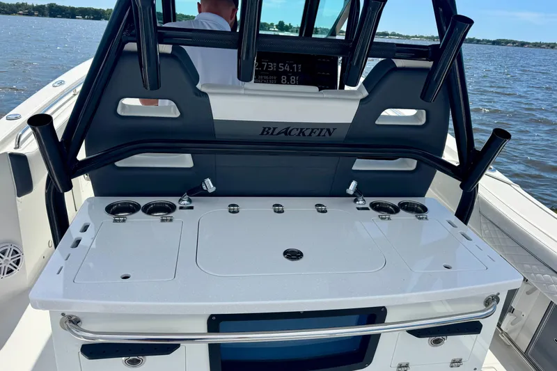 Slide: The Image of 2021 Blackfin 332 CC boat console with rod holders and control panel on water. - 50