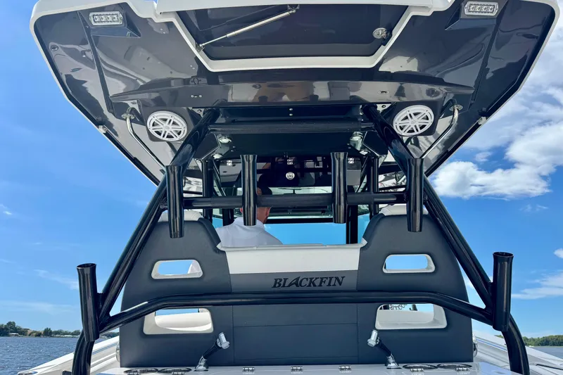 Slide: The Image of 2021 Blackfin 332 CC boat with sleek design and modern features on a sunny day. - 57