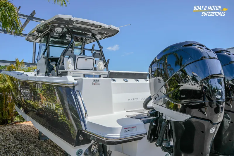 Slide: The Image of 2021 Blackfin 332 CC boat with dual engines, displayed outdoors. - 60