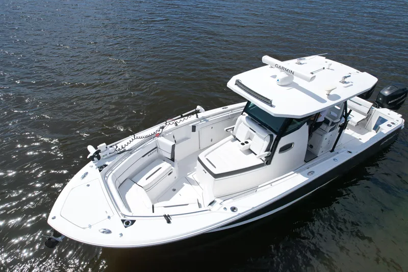 Slide: The Image of 2021 Blackfin 332 CC boat on water, featuring sleek design and advanced navigation equipment. - 7