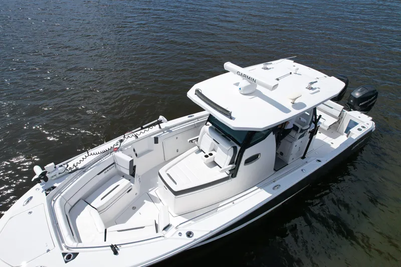 Slide: The Image of 2021 Blackfin 332 CC boat on water, featuring sleek design and advanced navigation equipment. - 8