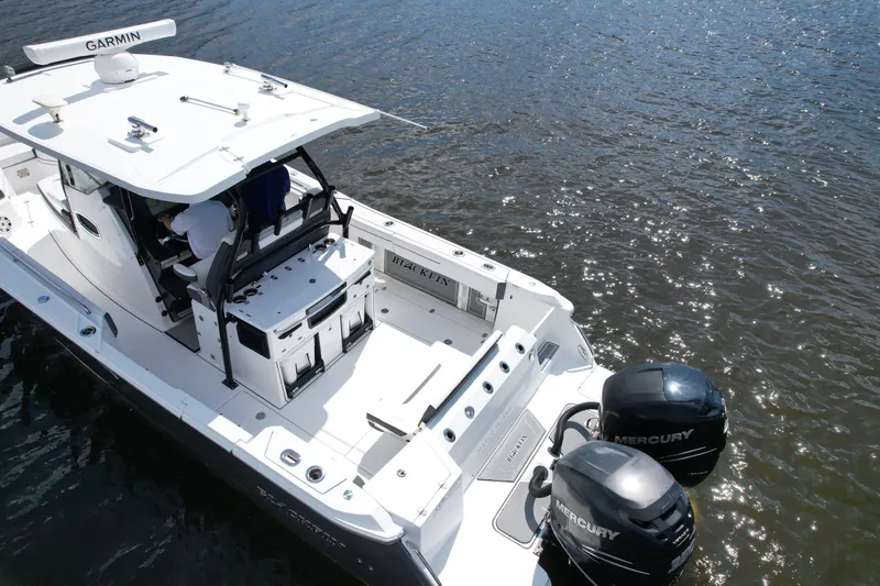 Slide: The Image of 2021 Blackfin 332 CC boat with dual Mercury engines on water. - 9