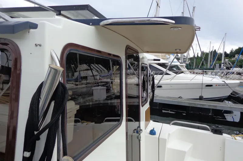 Slide: The Image of 2011 Ranger Tugs R-29 Classic docked, showcasing exterior details and marina setting. - 10