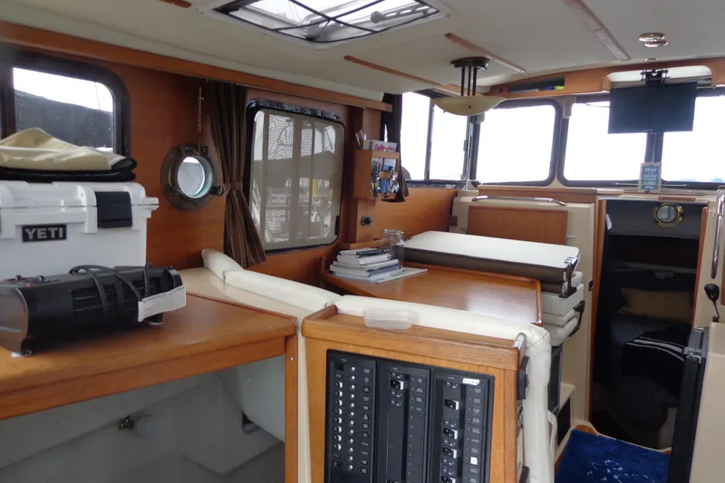 Slide: The Image of Interior of 2011 Ranger Tugs R-29 Classic boat, featuring cozy seating and modern amenities. - 14