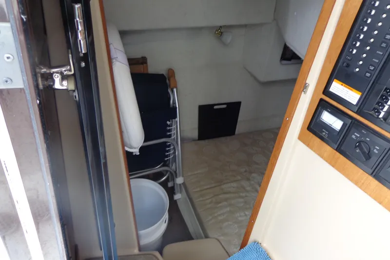 Slide: The Image of 2011 Ranger Tugs R-29 Classic cabin interior with control panel and storage. - 15