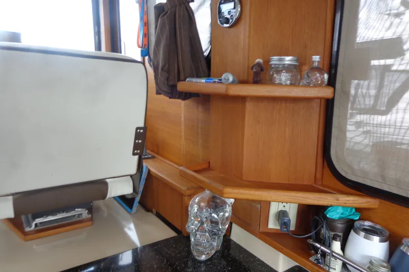 Slide: The Image of Interior of 2011 Ranger Tugs R-29 Classic, featuring wooden shelves and eclectic decor. - 29