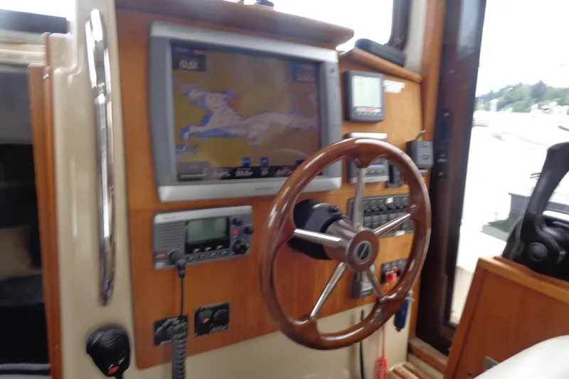 Slide: The Image of 2011 Ranger Tugs R-29 Classic helm with navigation equipment and wooden steering wheel. - 31