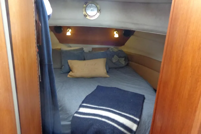 Slide: The Image of Cozy cabin interior of 2011 Ranger Tugs R-29 Classic, featuring a comfortable bed and nautical decor. - 33