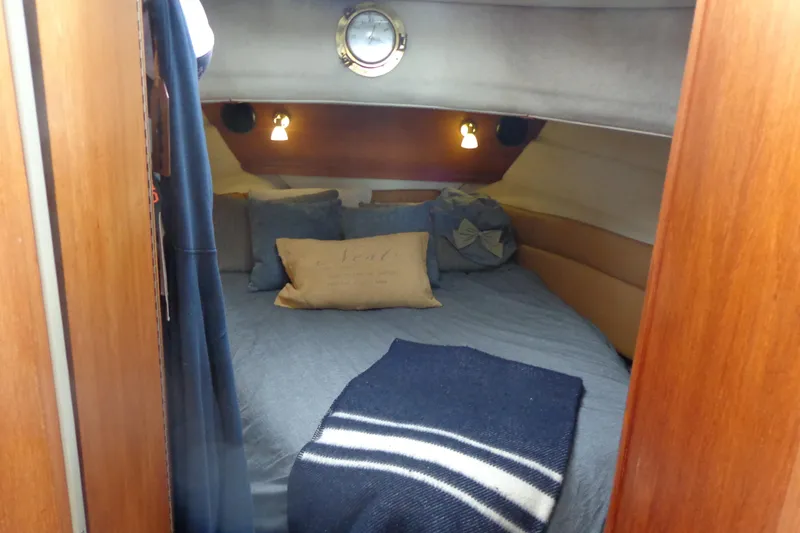 Slide: The Image of 2011 Ranger Tugs R-29 Classic cabin interior with cozy bed and nautical decor. - 34