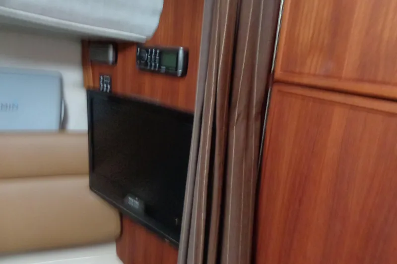 Slide: The Image of Interior of 2011 Ranger Tugs R-29 Classic, featuring wood paneling and electronic equipment. - 35