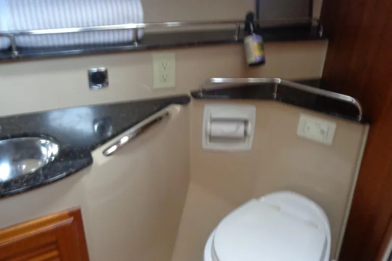 Slide: The Image of 2011 Ranger Tugs R-29 Classic bathroom with sink, toilet, and countertop. - 37
