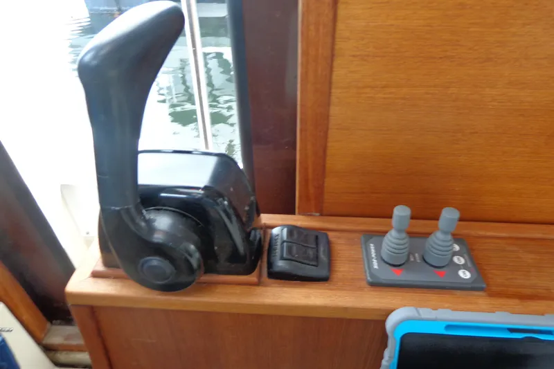 Slide: The Image of 2011 Ranger Tugs R-29 Classic boat controls with throttle and joystick on wooden panel. - 40