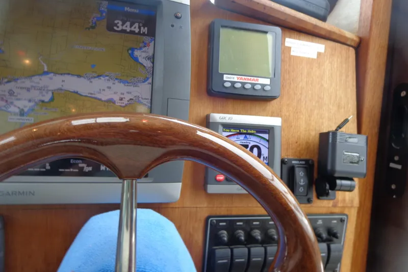 Slide: The Image of Steering wheel and navigation instruments on 2011 Ranger Tugs R-29 Classic boat. - 42
