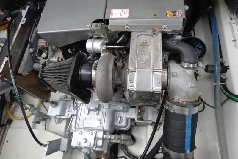 Slide: The Image of Engine compartment of a 2011 Ranger Tugs R-29 Classic with trailer, showcasing mechanical components. - 48