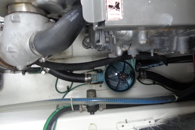Slide: The Image of Engine compartment of 2011 Ranger Tugs R-29 Classic, showcasing hoses and mechanical components. - 49