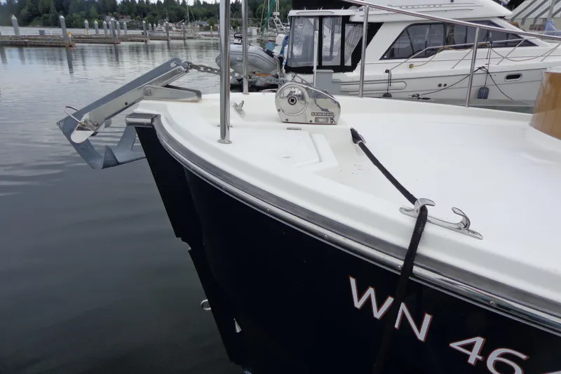Slide: The Image of 2011 Ranger Tugs R-29 Classic boat docked, featuring anchor and winch system. - 5