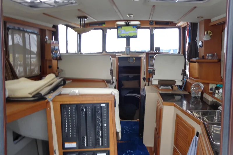 Slide: The Image of Interior of 2011 Ranger Tugs R-29 Classic boat, featuring navigation equipment and cozy seating. - 57