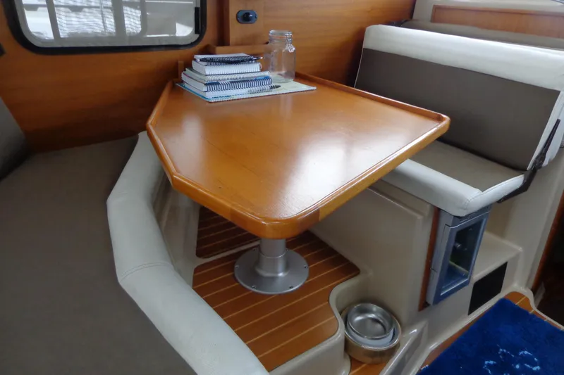 Slide: The Image of 2011 Ranger Tugs R-29 Classic interior with wooden table and seating area. - 58