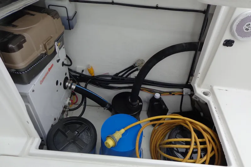 Slide: The Image of 2011 Ranger Tugs R-29 Classic engine compartment with generator, cables, and storage. - 63