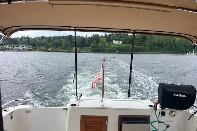 Slide: The Image of 2011 Ranger Tugs R-29 cruising on a lake with American flag waving. - 66