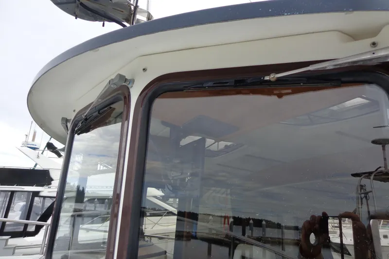 Slide: The Image of 2011 Ranger Tugs R-29 Classic boat window detail with trailer. - 8