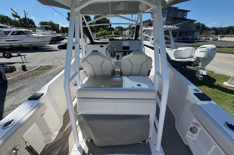 Slide: The Image of 2026 Solara S-250 CW boat interior with modern helm and seating, docked outdoors. - 10