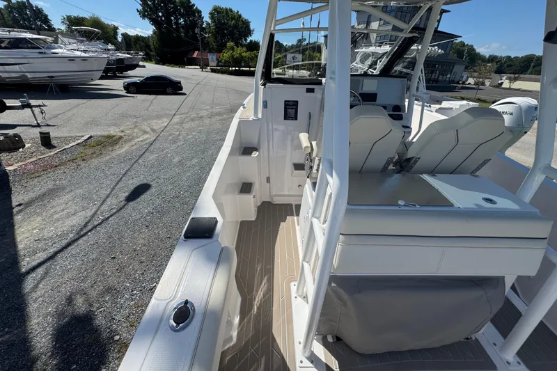 Slide: The Image of 2026 Solara S-250 CW boat interior with seating and control panel, docked outdoors. - 12