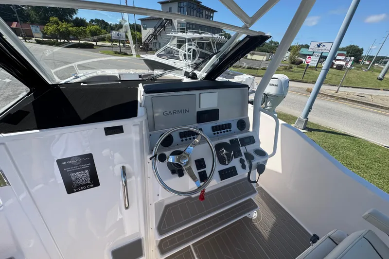 Slide: The Image of 2026 Solara S-250 CW boat cockpit with Garmin navigation system and steering wheel. - 14