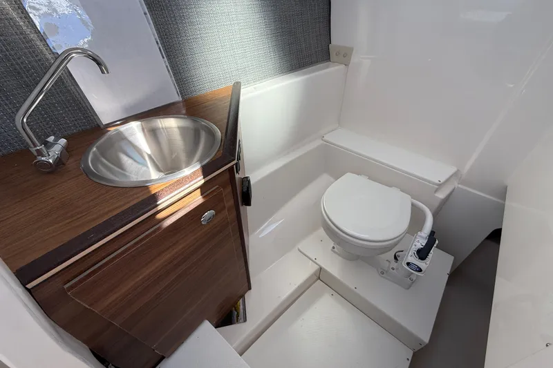 Slide: The Image of Compact bathroom in 2026 Solara S-250 DC boat with sink and toilet. - 12
