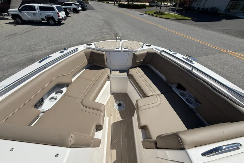 Slide: The Image of 2026 Solara S-250 DC boat interior with beige seating and cup holders. - 13