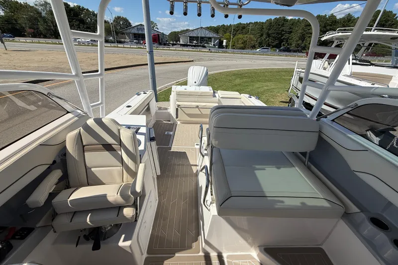 Slide: The Image of 2026 Solara S-250 DC boat interior with seating, helm, and open deck under sunny skies. - 14