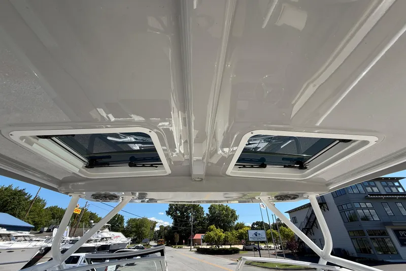 Slide: The Image of Rooftop view of 2026 Solara S-250 DC boat with open hatches and clear sky. - 17