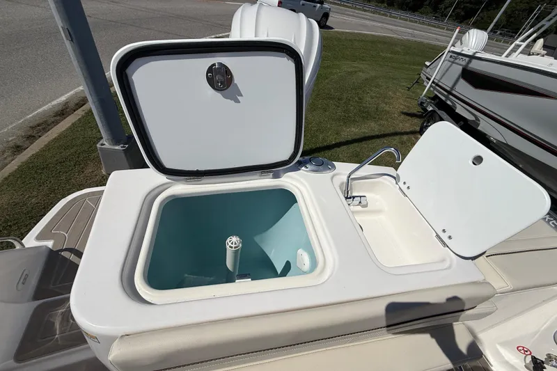 Slide: The Image of Open storage compartment and sink on 2026 Solara S-250 DC boat. - 18